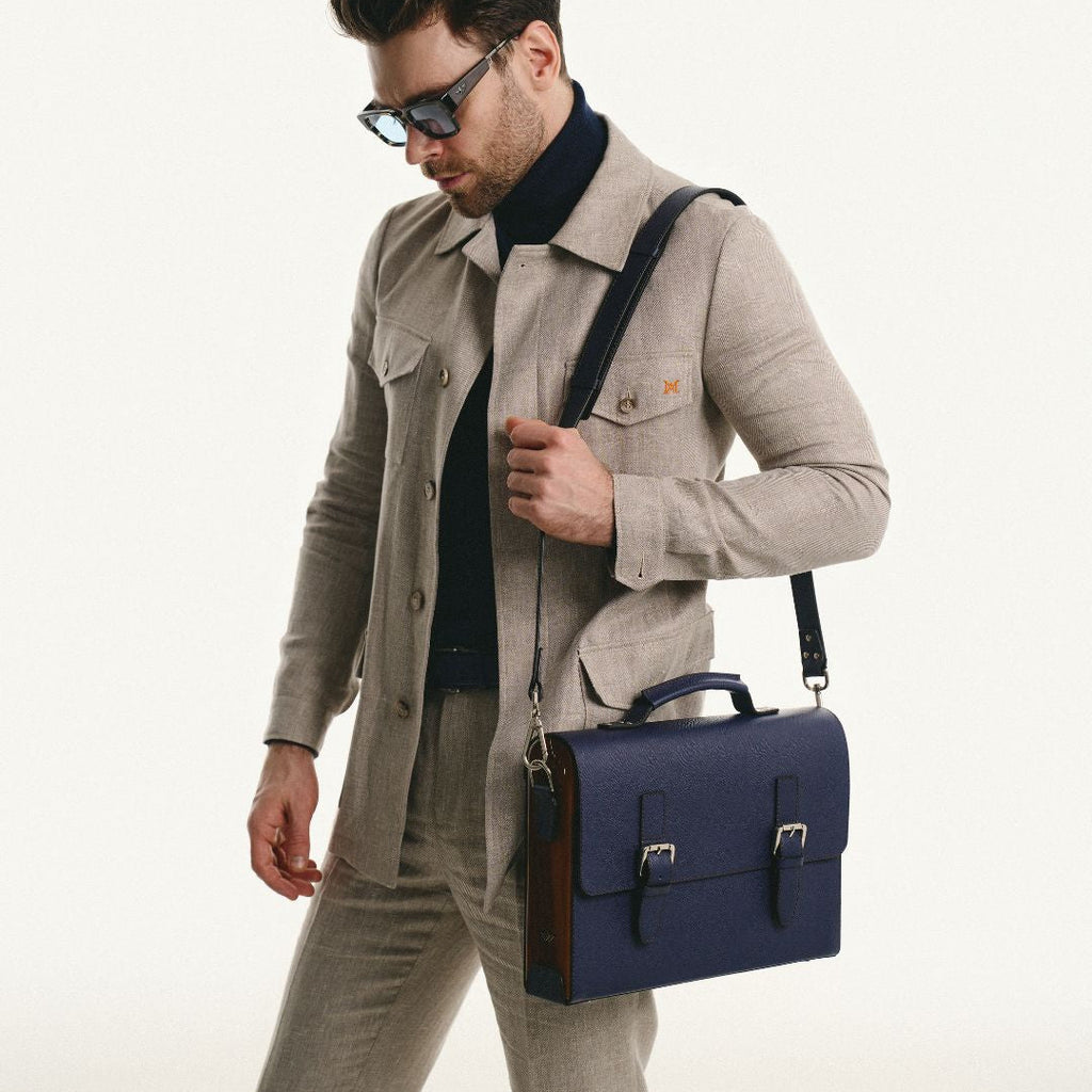 Man holding a navy blue leather briefcase 