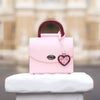 BLACKWOOD Aurora Purple Heart Shiny Rose handbag styled in an elegant interior setting