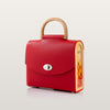Red handbag with wooden handle and side panel 