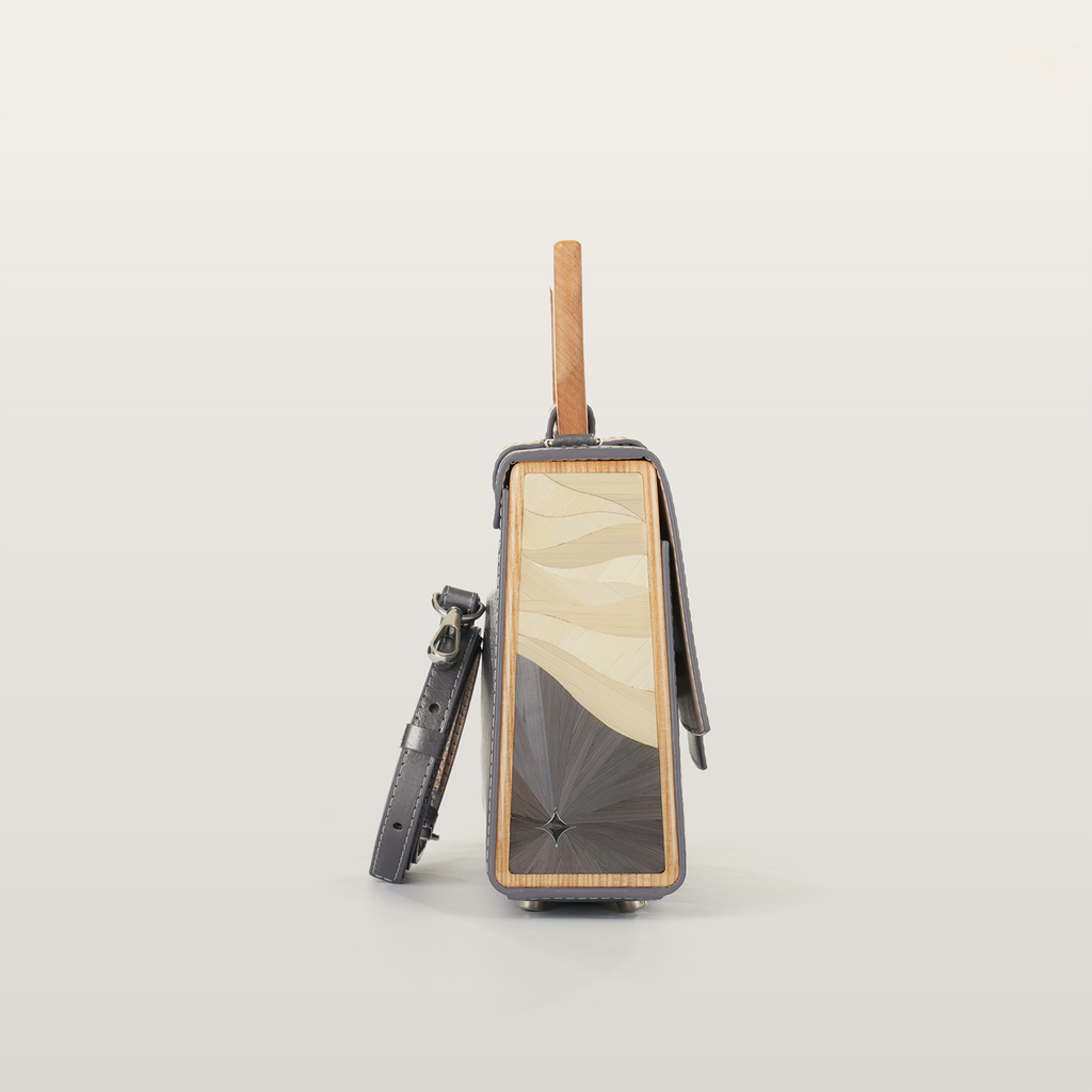Side view of Sandy Povitrulia bag featuring geometric straw marquetry sealed under jewelry resin by RUDA Studio