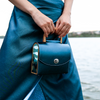 Handcrafted Aurora Vodianytsia bag with metallic teal leather and custom round lock detail
