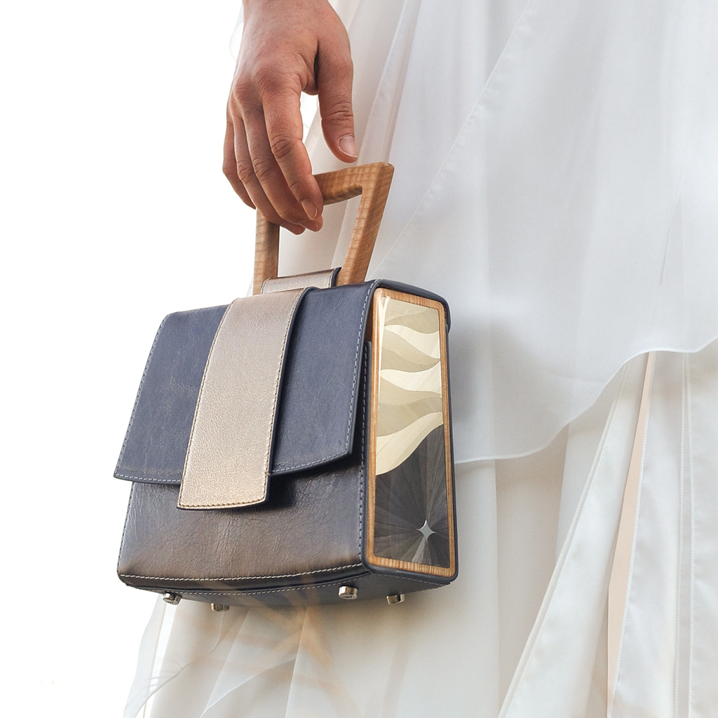 Architectural wooden handle and rye straw marquetry side panel on the Sandy Povitrulia bag