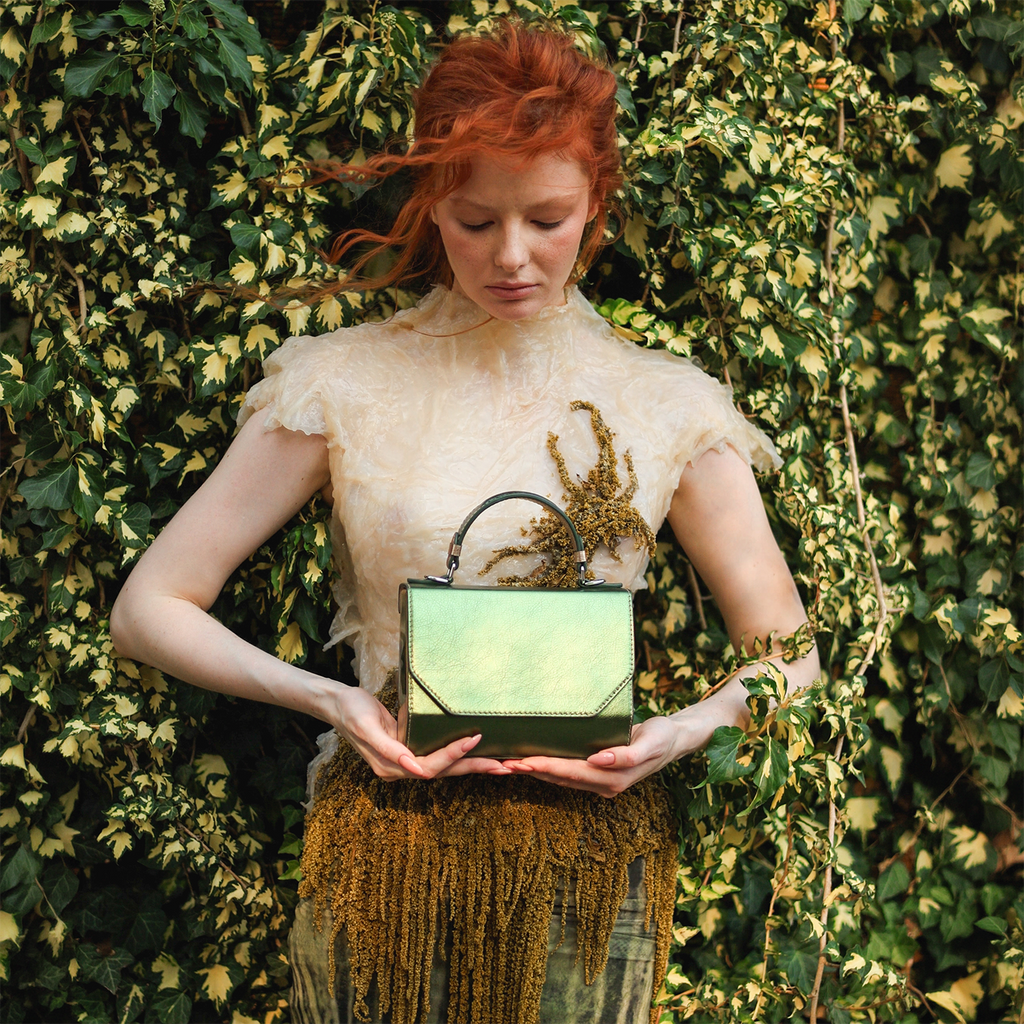 Model holding the limited edition ANIMA Fjord Mavka handbag handcrafted by BLACKWOOD