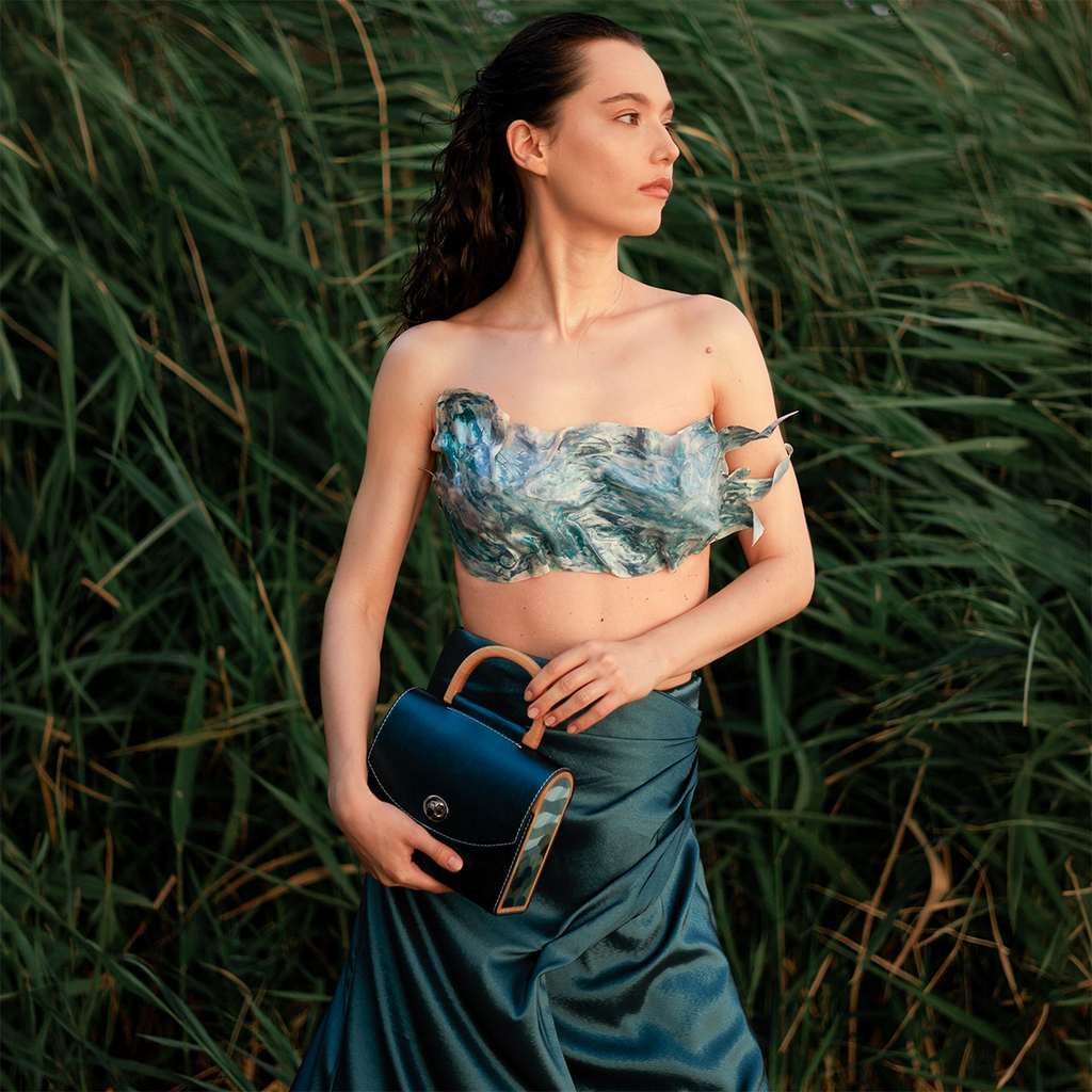 Model holding the limited edition ANIMA Aurora Vodianytsia handbag handcrafted by BLACKWOOD