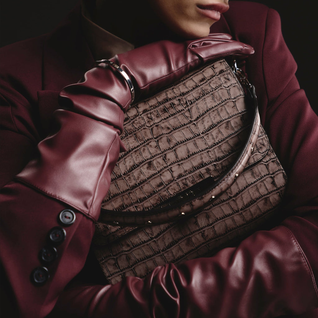Model holding BLACKWOOD Gloria Brown Croco leather handbag in an elegant evening look