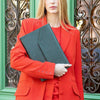 Green Saffiano leather MacBook case styled with a premium everyday look