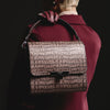 Model carrying BLACKWOOD Gloria Brown Croco leather handbag with structured top handle